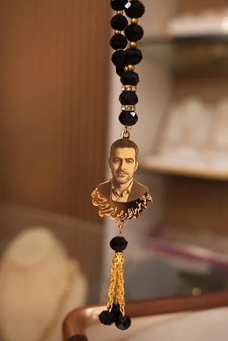 A rosary with details including a picture and a special name
